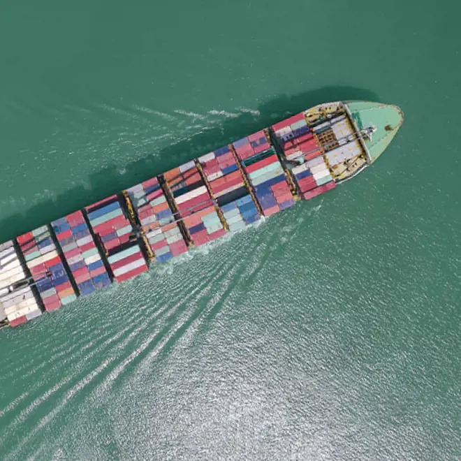image of a sailing container ship