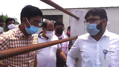 A group of men wearing face masks and inspecting an oxygen plant