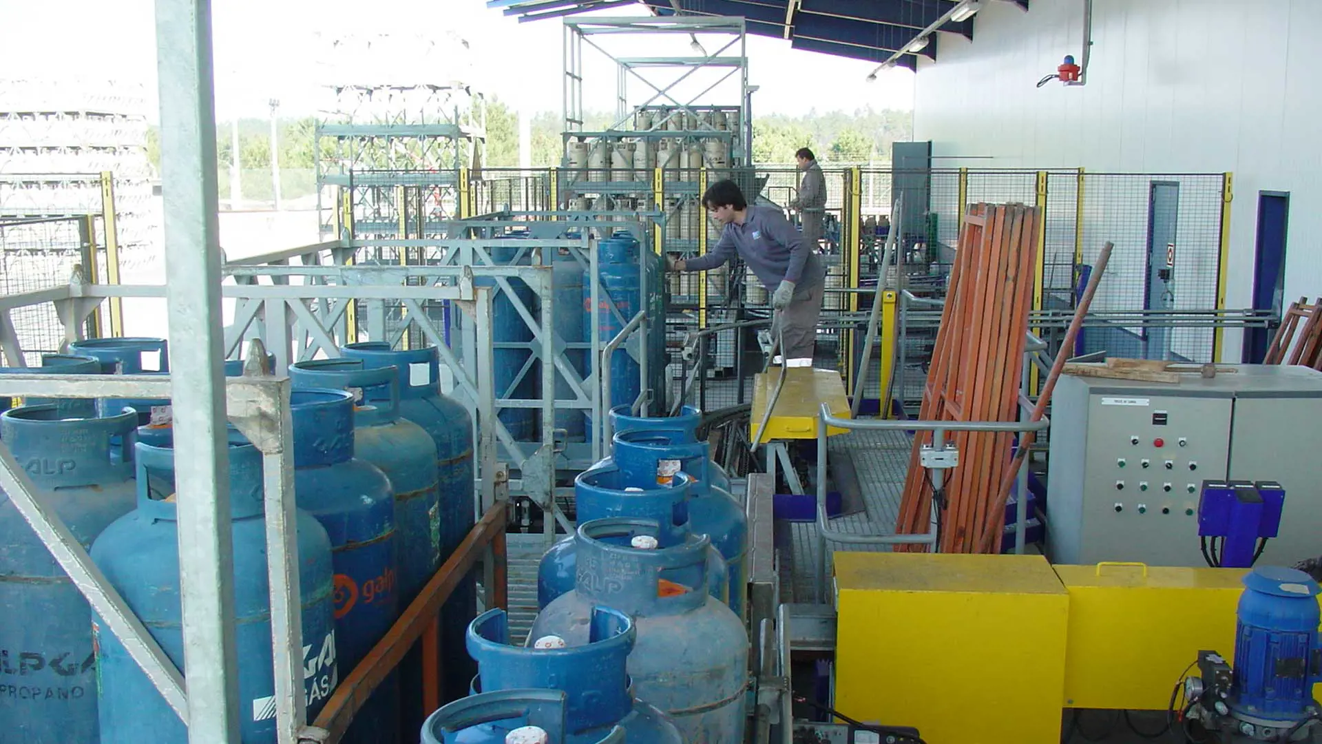 A facility manager handling gas cylinders
