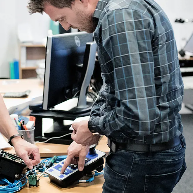 Image of a man checking MAKEEN universal controller