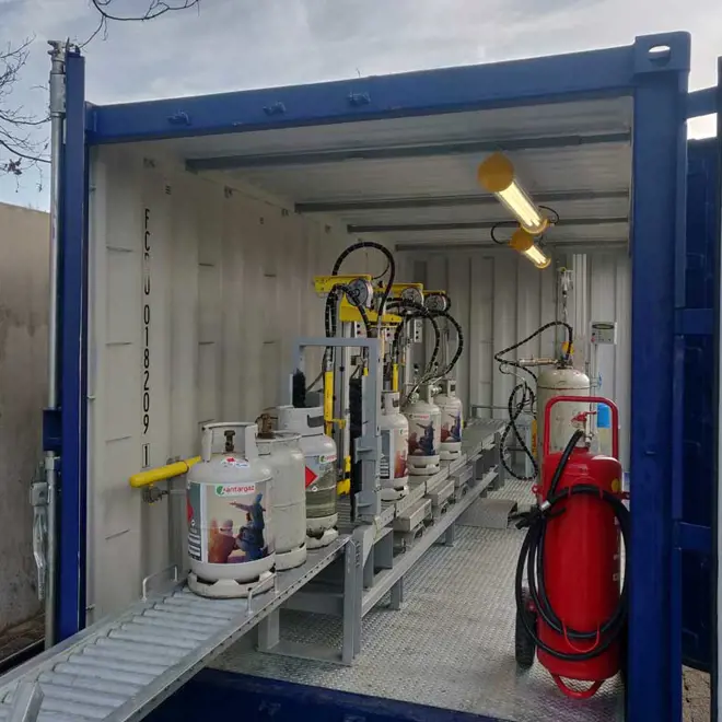 An image of cylinders on a conveyer belt in a cargo container