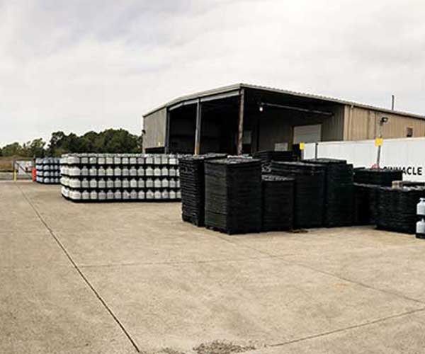 Cylinders and pallets stacked in front of an LPG filling facility