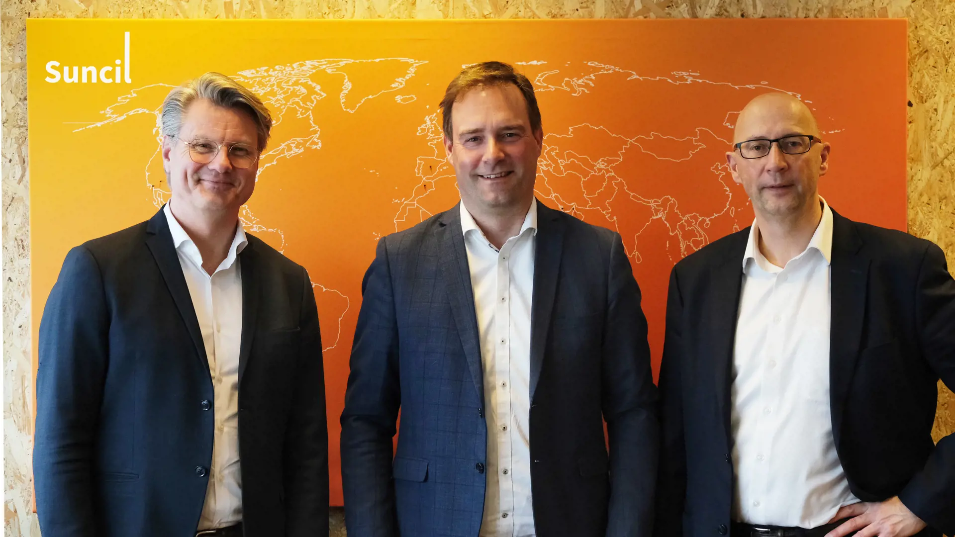 Bo Larsen, Lars Bjørn and Anders C. Anderson standing infront of a Suncil poster