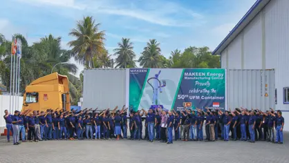 Group photo of MAKEEN Energy Sri Lanka staff pointing at a banner