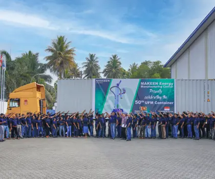 Group photo of MAKEEN Energy Sri Lanka staff pointing at a banner