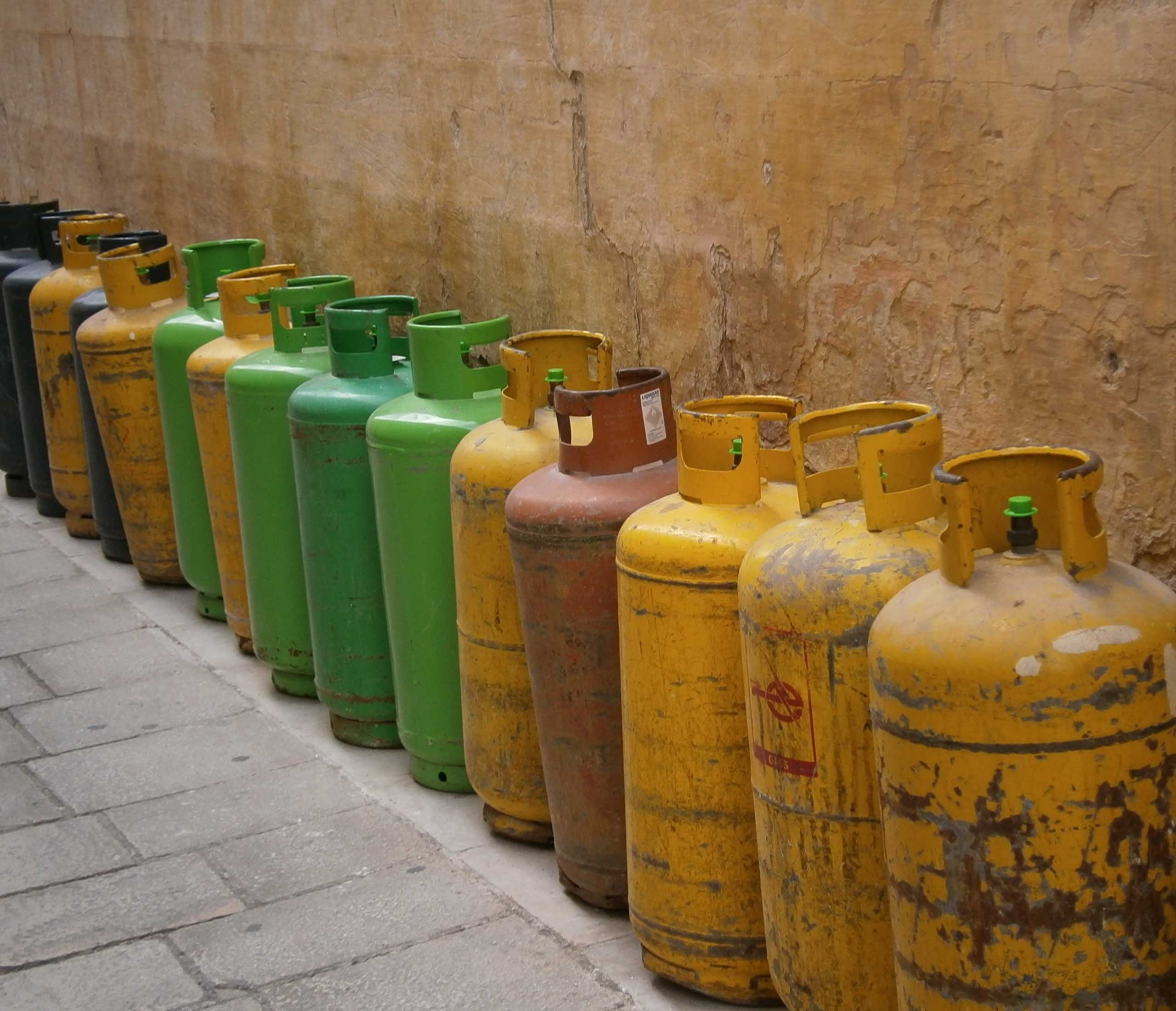 LPG cylinders lined up against a wall