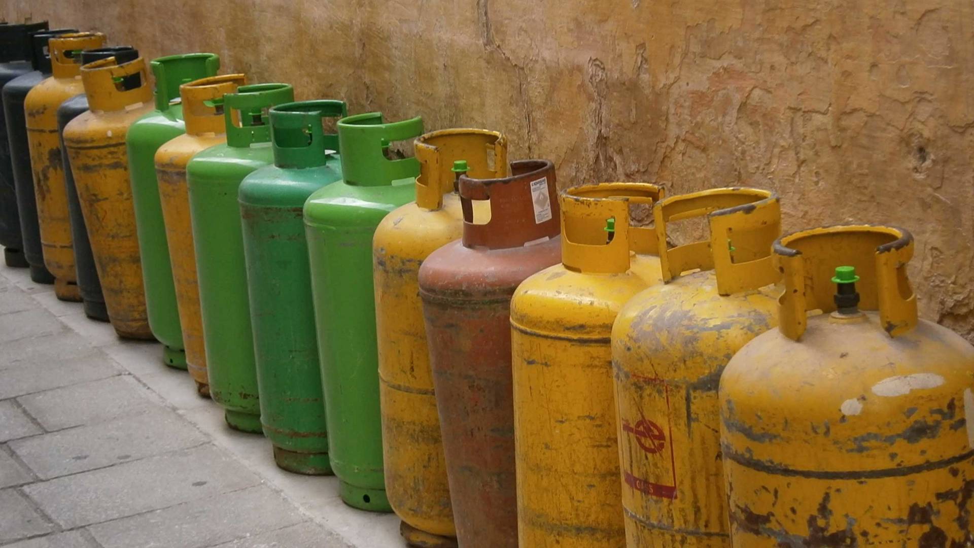 LPG cylinders lined up against a wall
