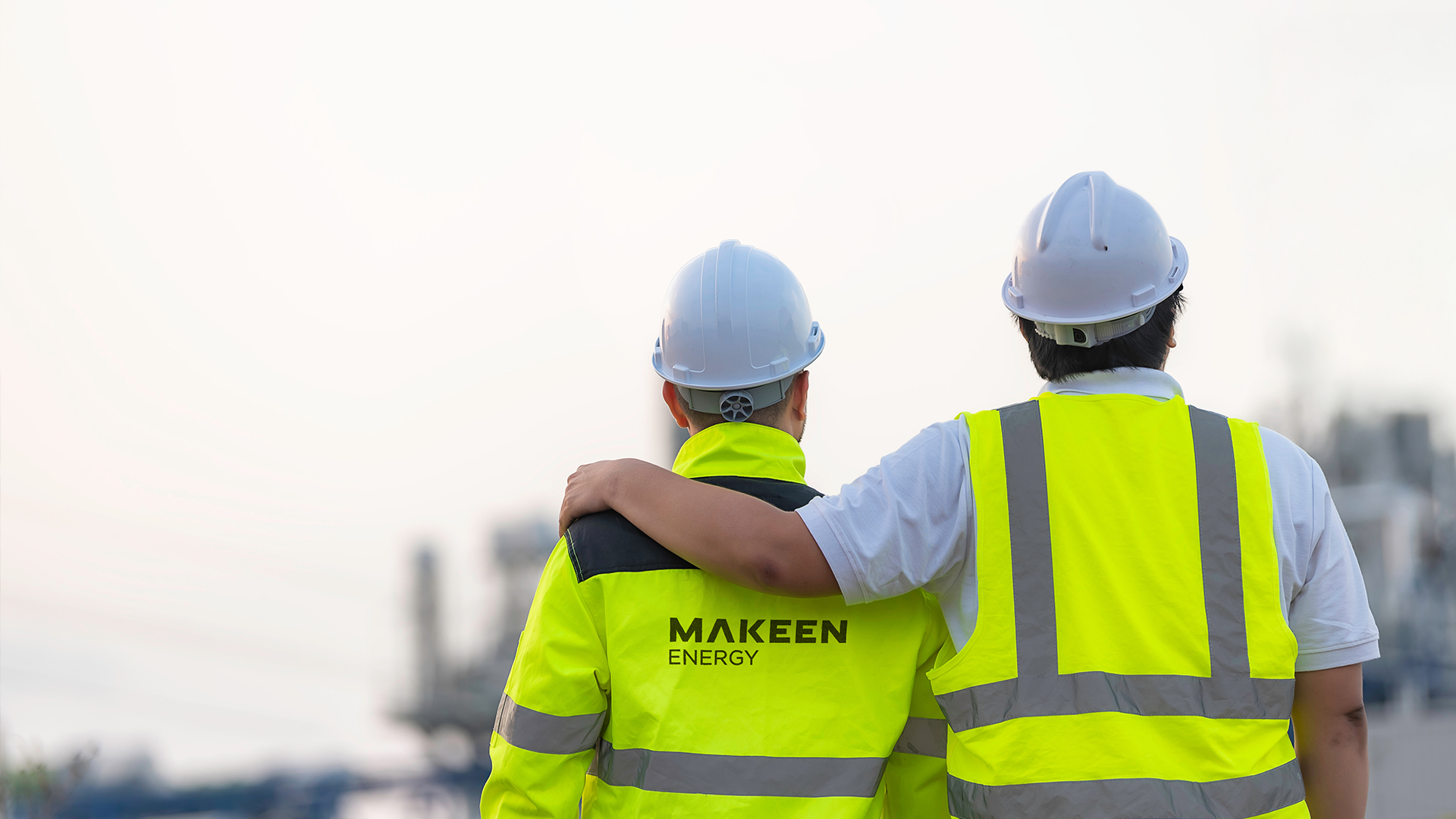 two people in safety vest white MAKEEN Energy logo on the back