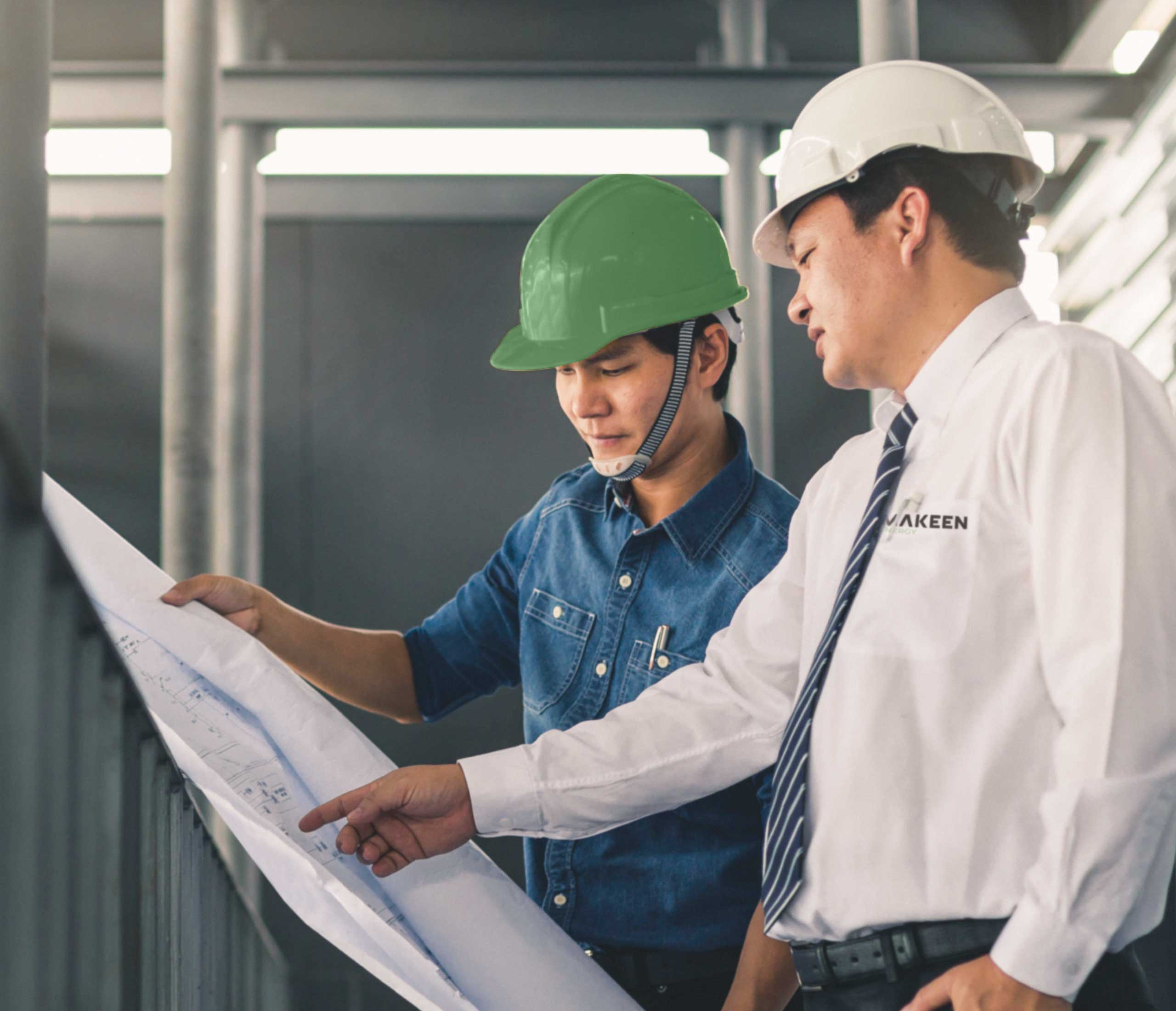 image of to men with helmets looking at a technical drawing