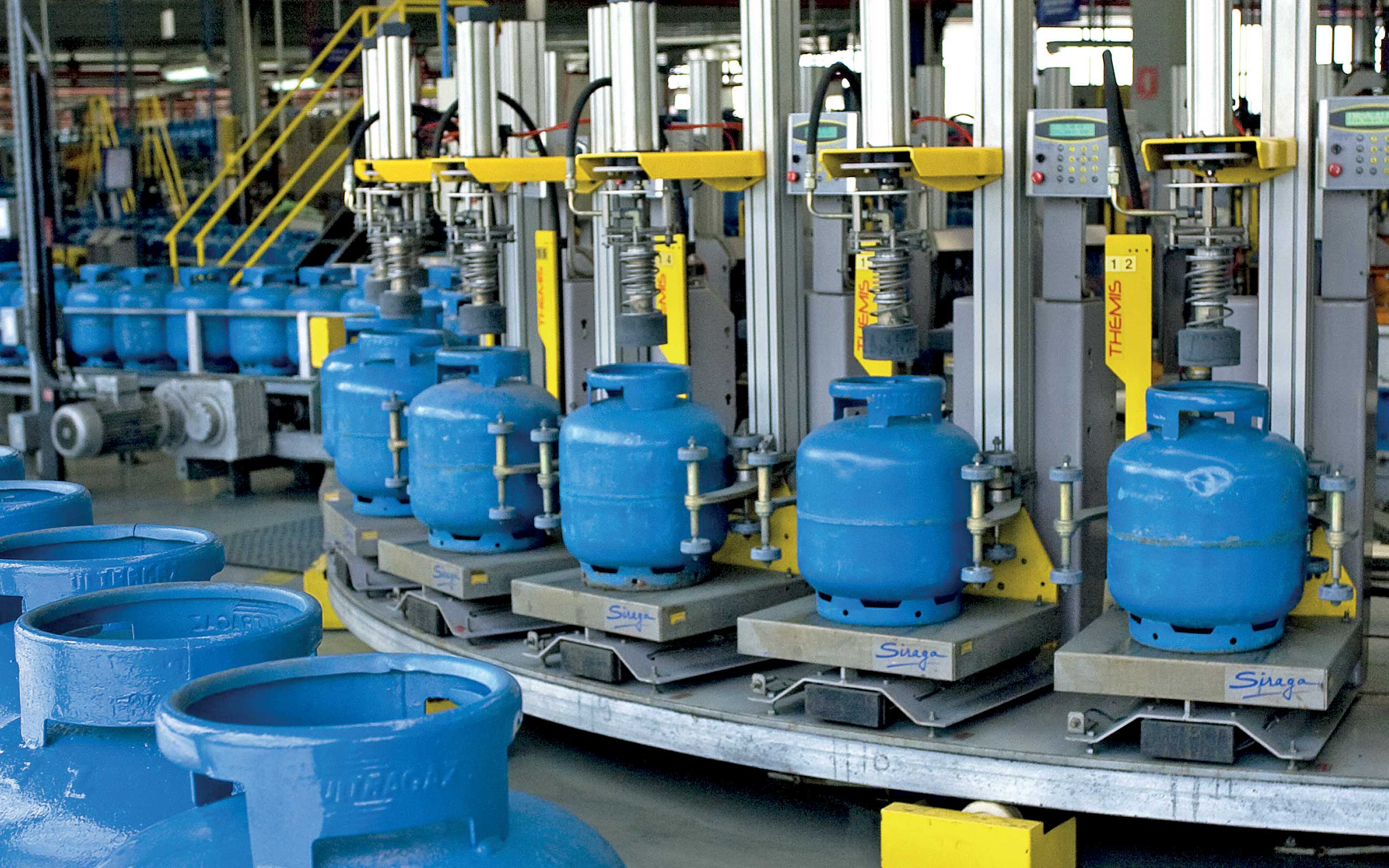 Blue LPG cylinders on a Siraga filling carrousel