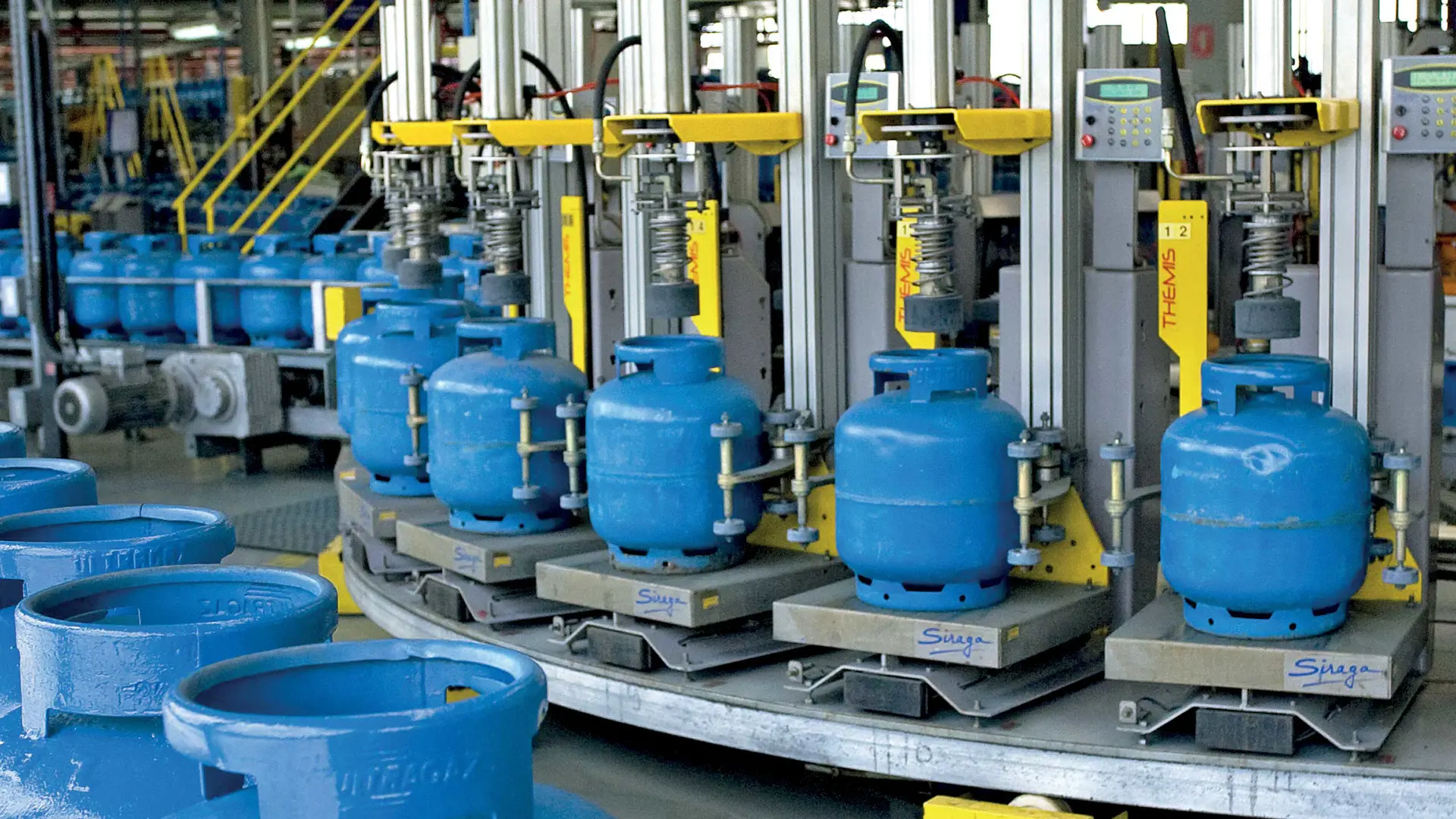 Blue LPG cylinders on a Siraga filling carrousel