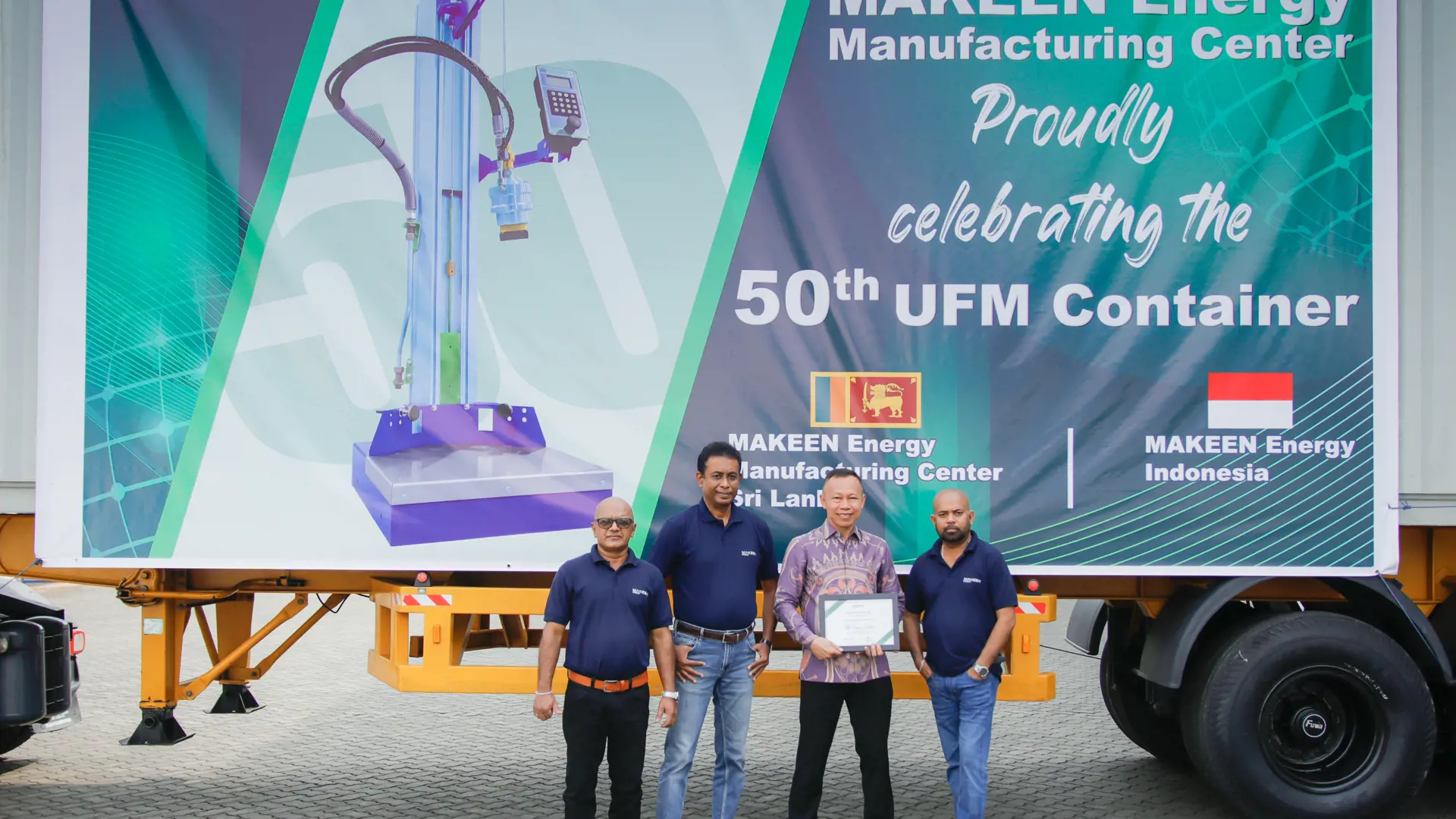 MAKEEN Energy staff from Sri Lanka and Indonesia posing in front of a truck with a banner