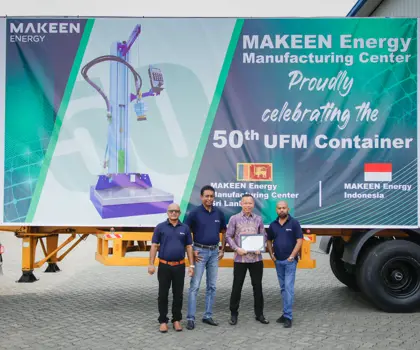 MAKEEN Energy staff from Sri Lanka and Indonesia posing in front of a truck with a banner