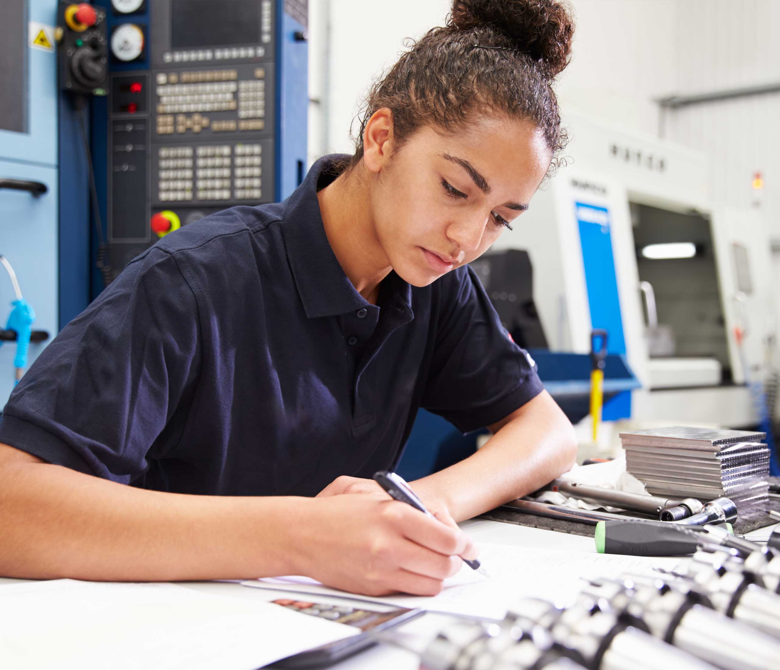 image of a female engineer writing in a notebook