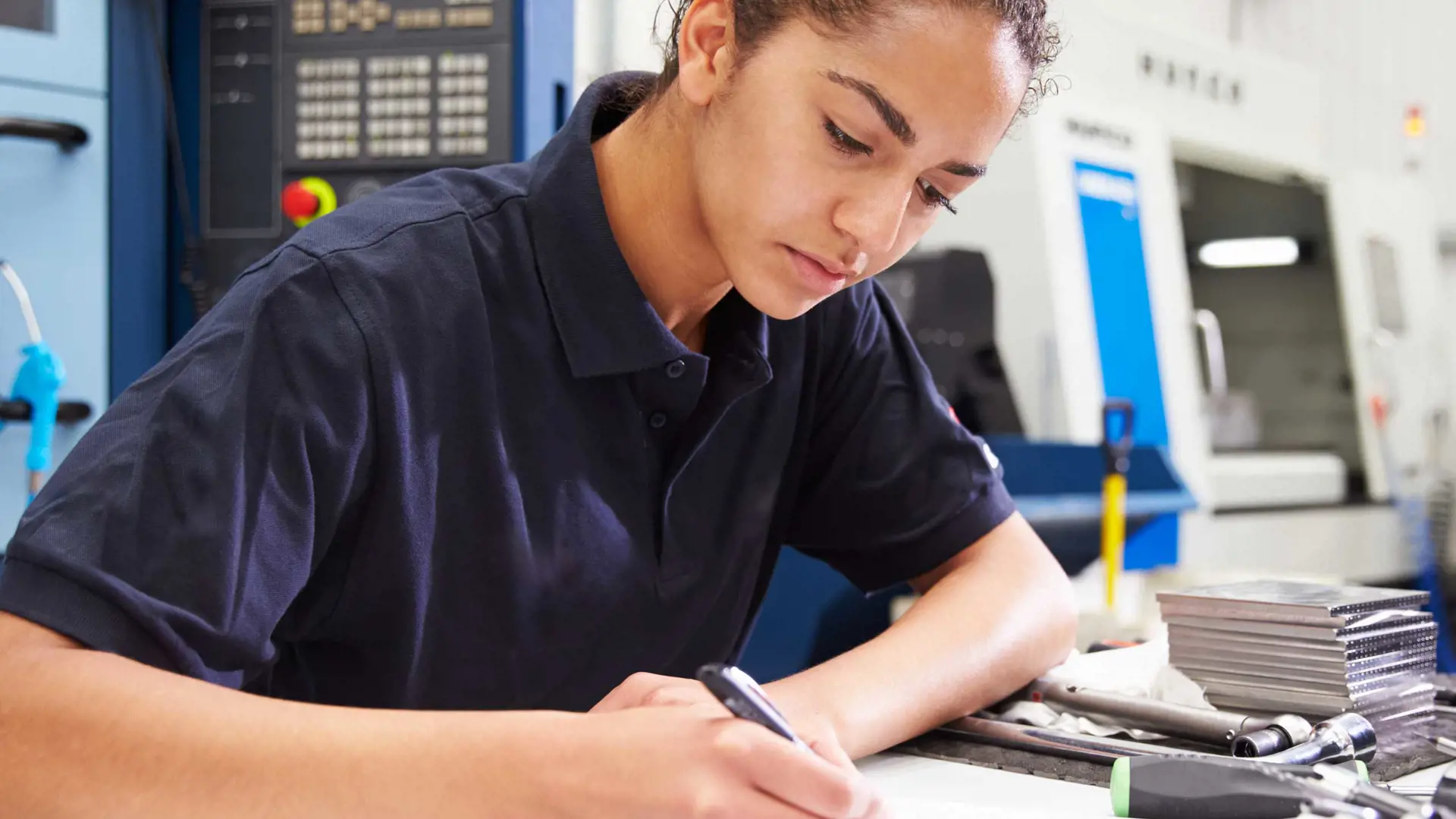 image of a female engineer writing in a notebook