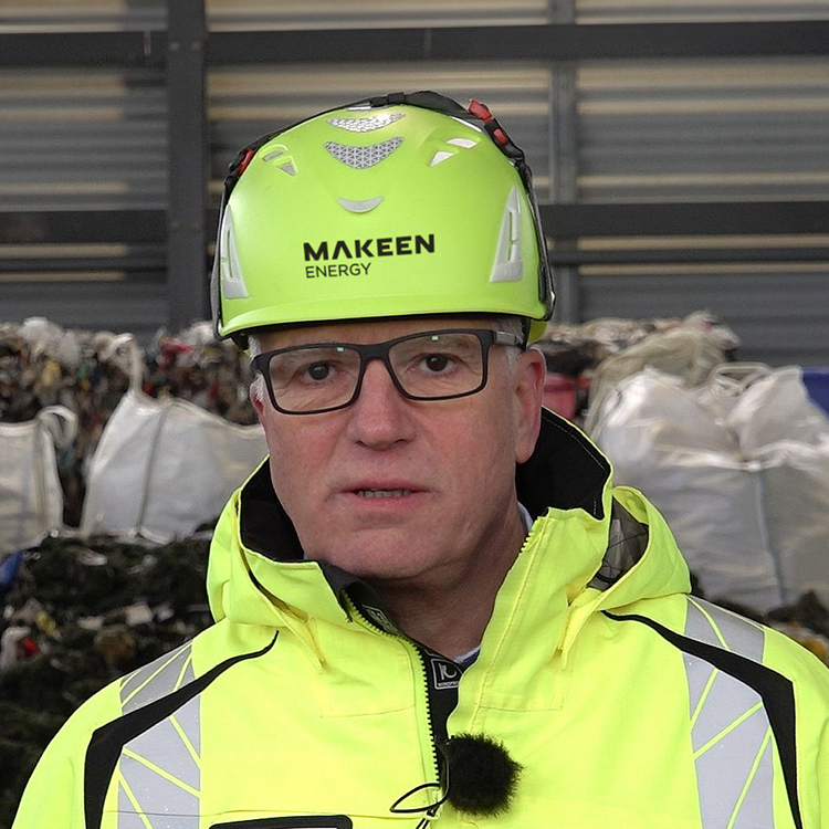 image of a middle-aged guy with glasses yellow jacket and helmet and microphone ABJ